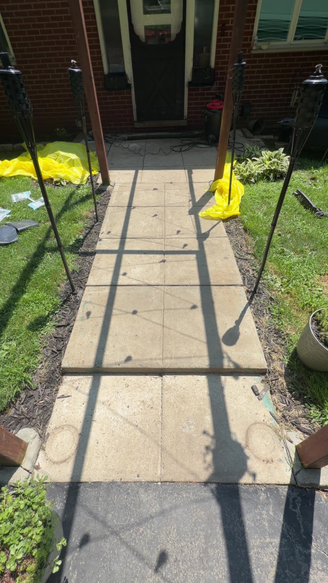 Worn, stained concrete walkway before garage-grade coating was applied