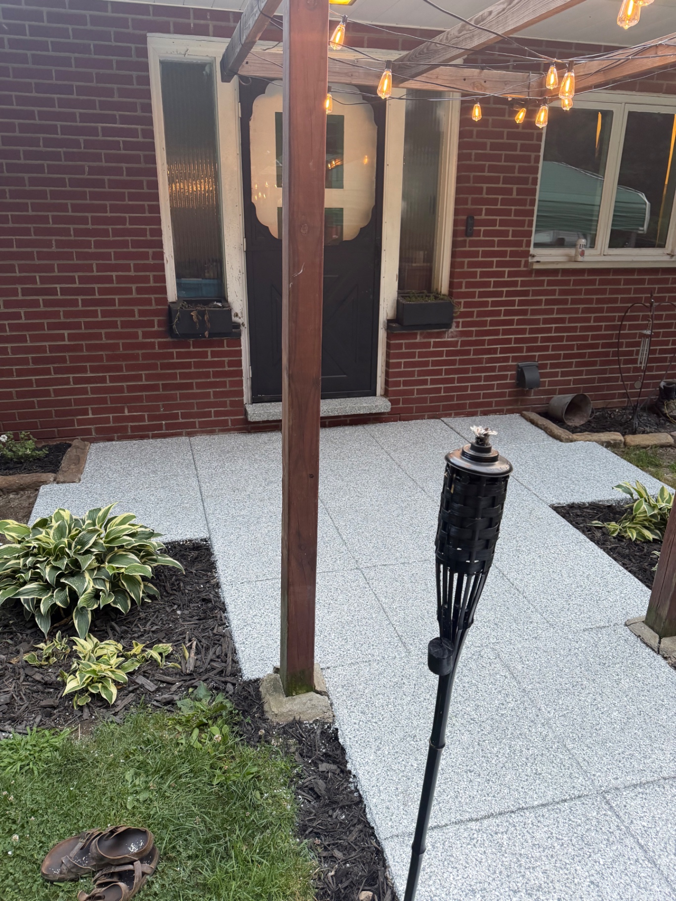 Flake-coated concrete patio and walkway under string lights